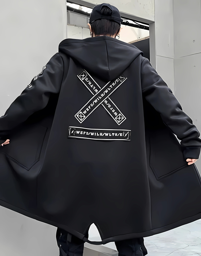 Person wearing a black coat with a large logo on the back, standing in an urban setting.