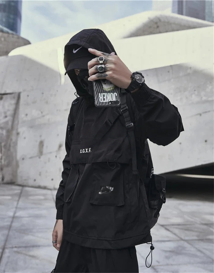 Person wearing a black jacket and pants in an urban setting